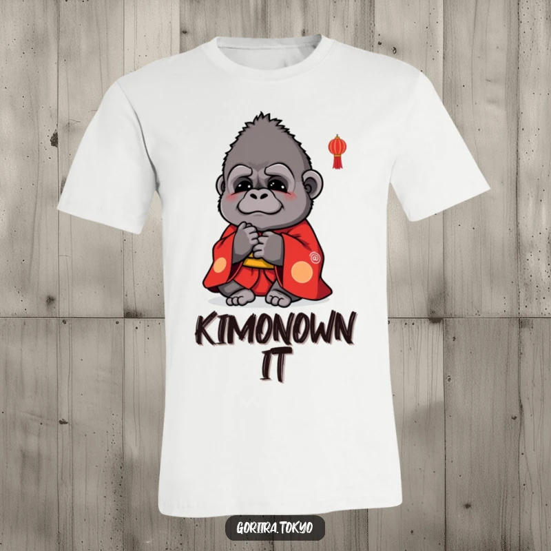 Funny t-shirt graphic: a small, cute gorilla wearing a vibrant red kimono, bowing politely with a warm expression.